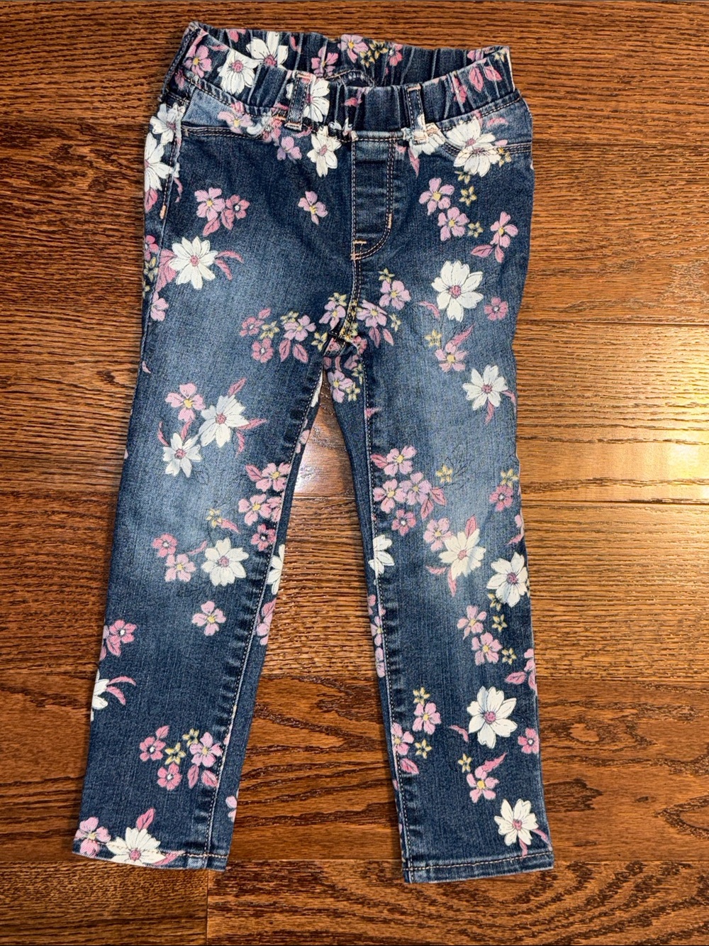 Size 5 toddler girl denim jeggings with pink and white florals from Gap.